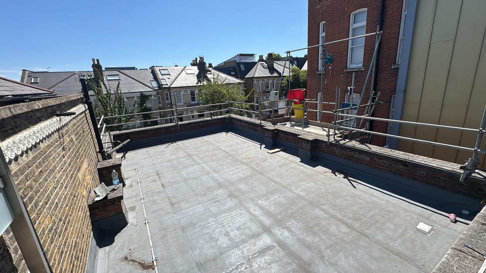Guardrail edge protection around a flat roof terrace on a London property during roofing works
