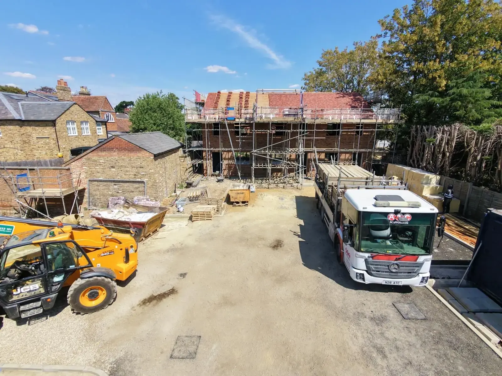 ATC Scaffolding lorry on a new build development with scaffolding erected to the full height of the brickwork and roof