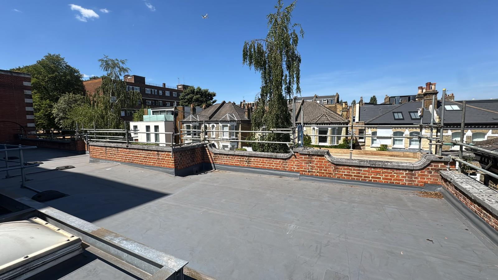 Continuous scaffold edge protection to the perimeter of a newly finished flat roof above a London terrace