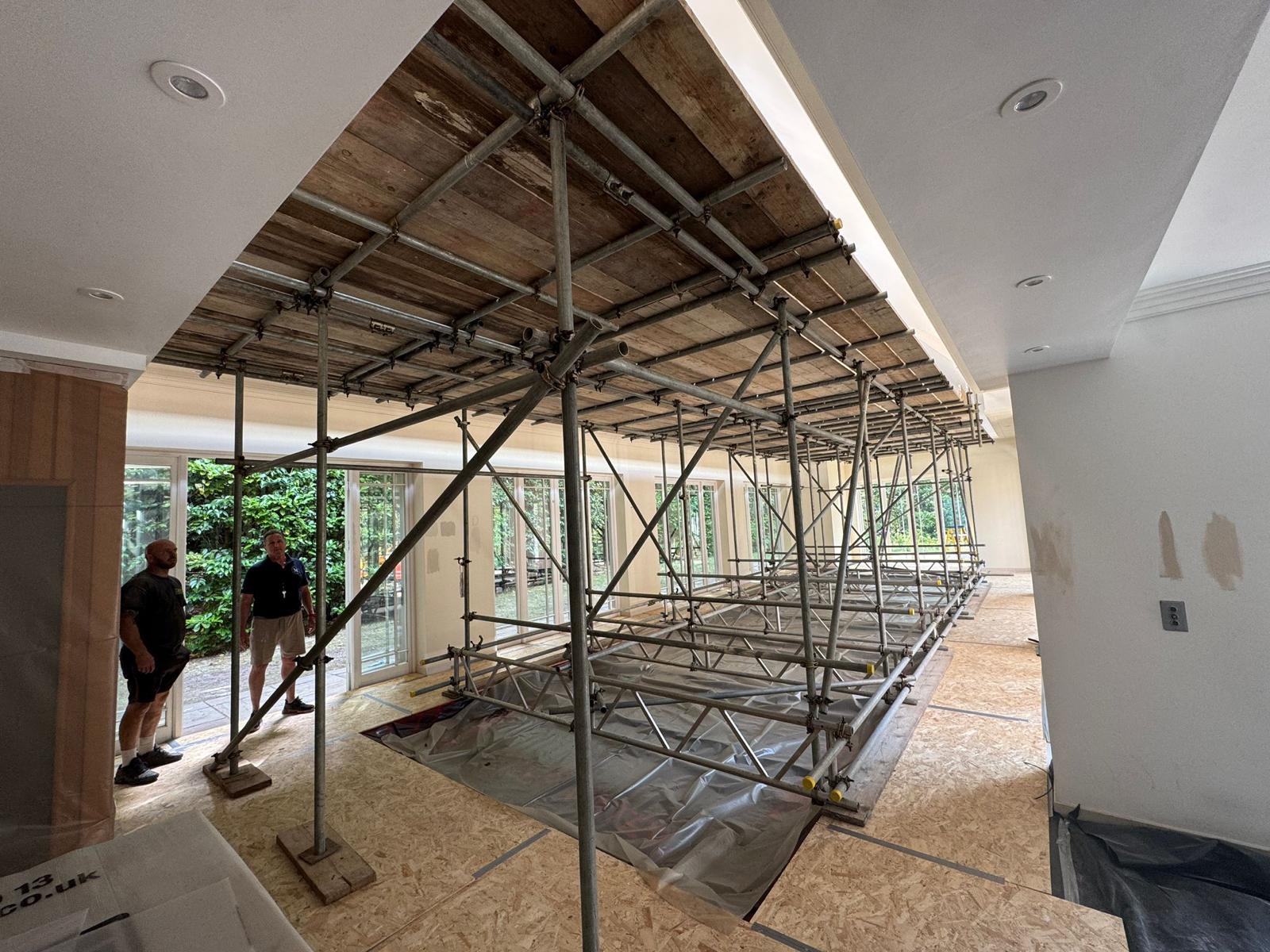 Internal birdcage support scaffold back propping a stripped ceiling inside a large residential property